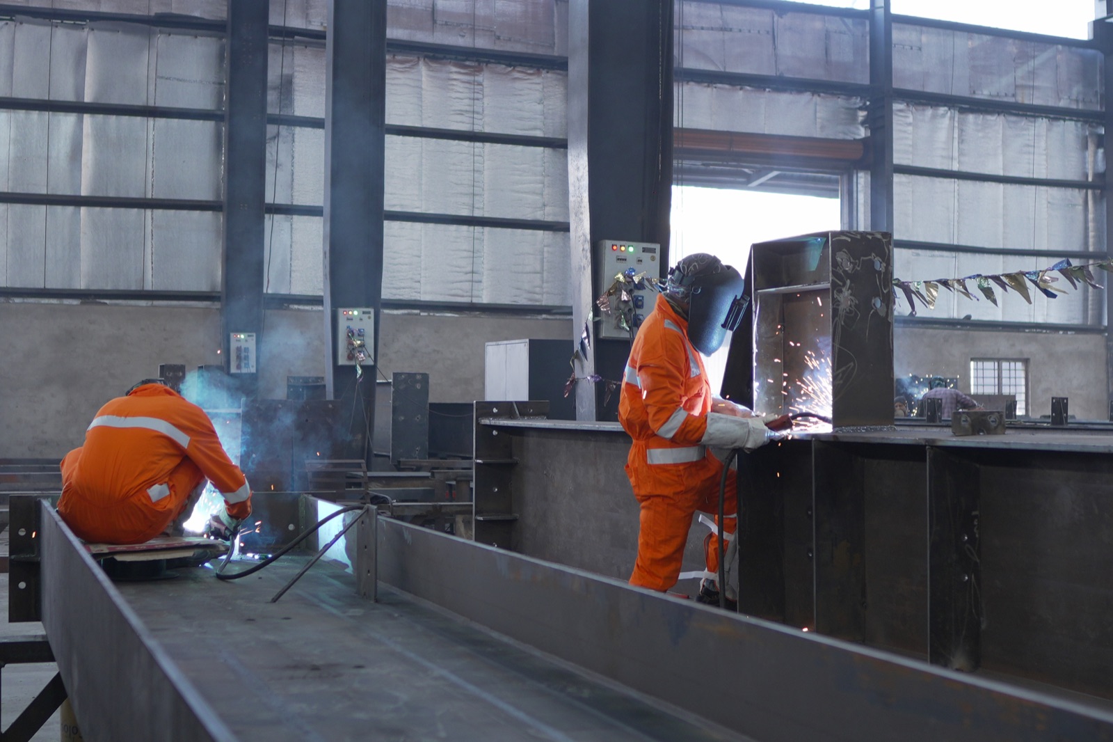 Skilled welders fabricating structural steel at Yash Engicon